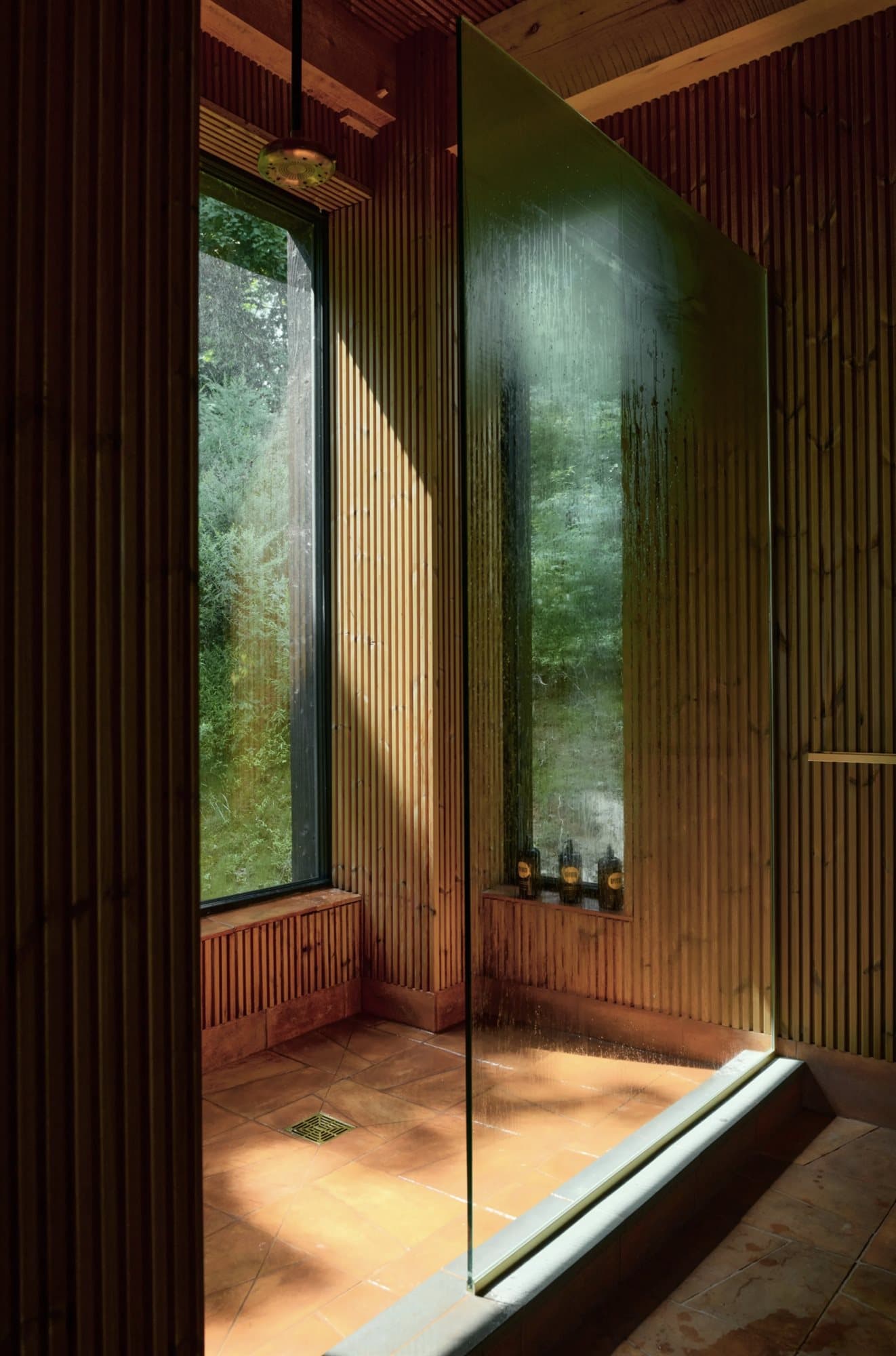 Corner windows opening the interior to the surrounding forest