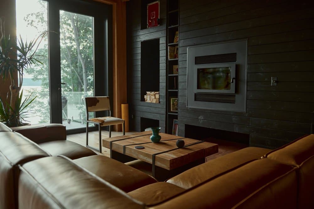 Living room with sofa and floor-to-ceiling river views
