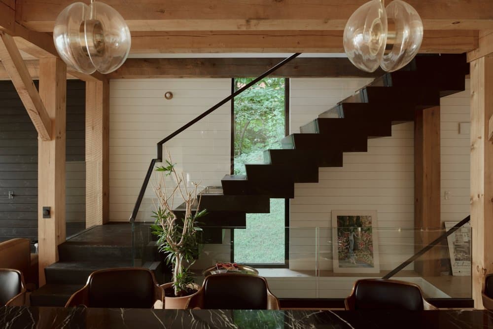 Floating stair set against exposed timber framing