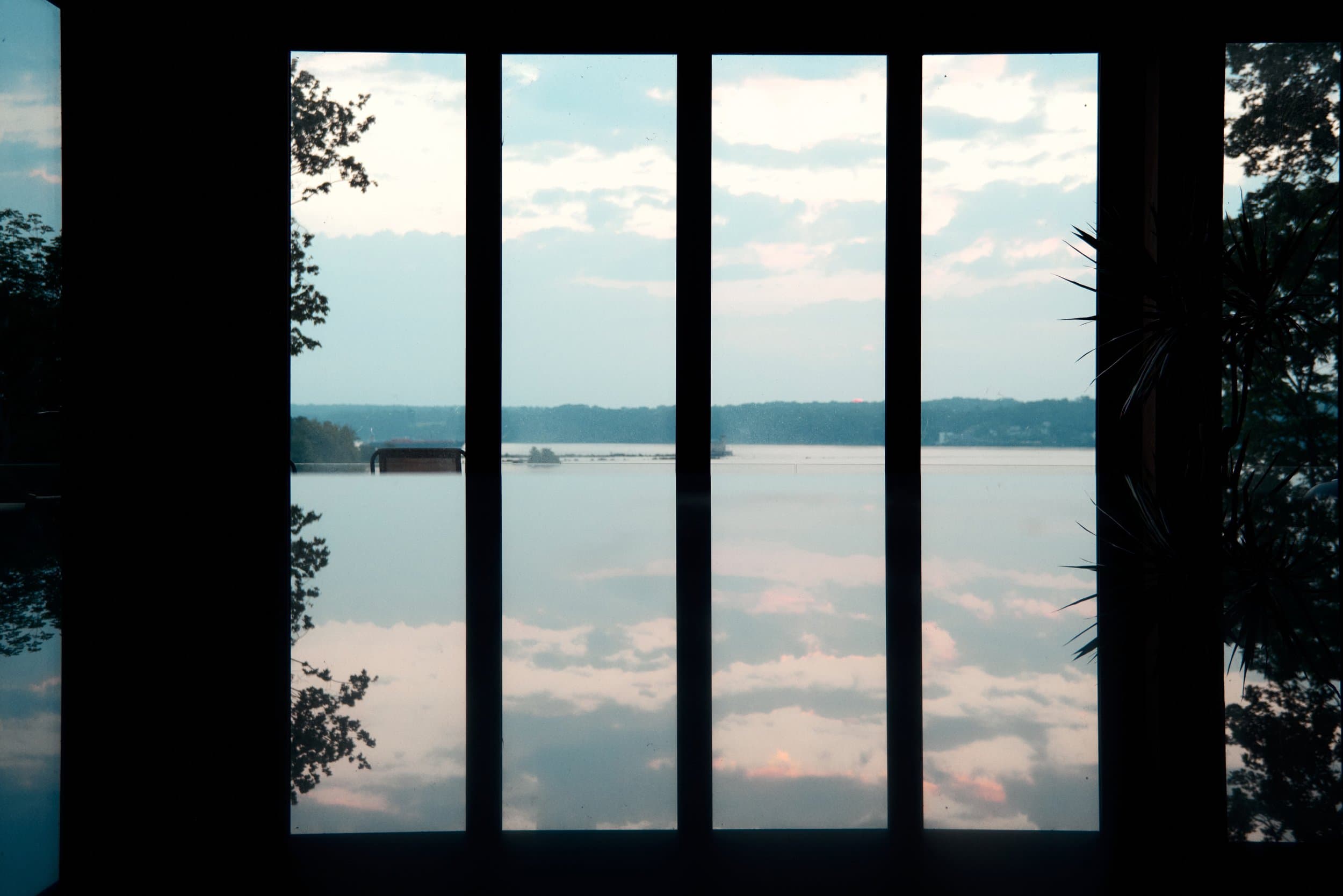 Enormous windows framing the Hudson River and its reflected sky