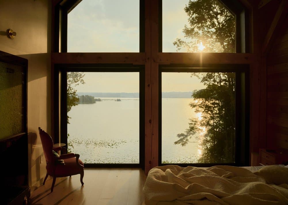 Enormous windows framing the river at sunset