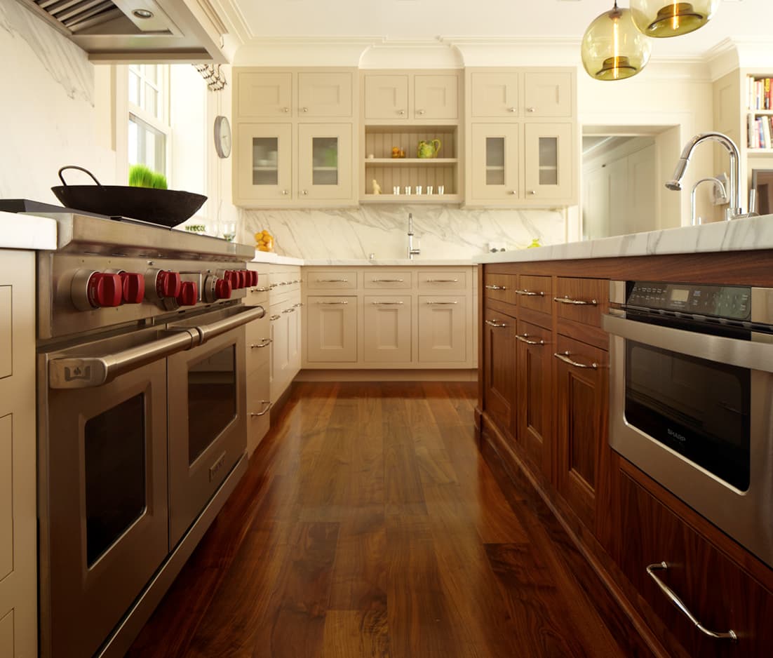 Kitchen range and marble counters with custom cabinetry