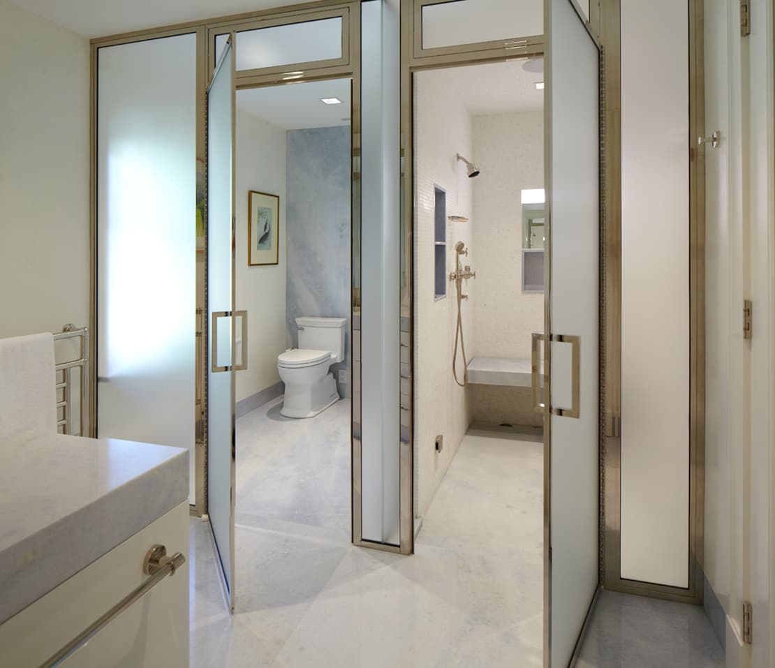 Master bath with glass shower and marble finishes